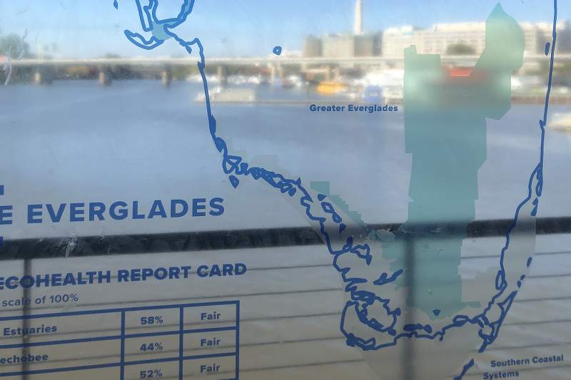Photo taken through a transparent image of the Everglades Report Card looking to the Washington Monument from the District Wharf in Washington, D.C., where "The Future of Water" fly-in was held.